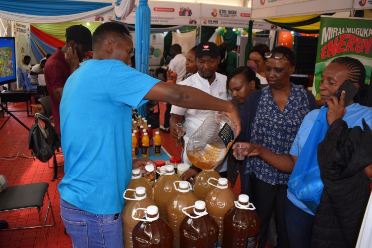 Visitors in the University of Nairobi booth sampling Pera foods  products